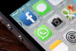 SAN FRANCISCO, CA - FEBRUARY 19: The Facebook and WhatsApp app icons are displayed on an iPhone on February 19, 2014 in San Francisco City. Facebook Inc. announced that it will purchase smartphone-messaging app company WhatsApp Inc. for $19 billion in cash and stock. (Photo illustration by Justin Sullivan/Getty Images)